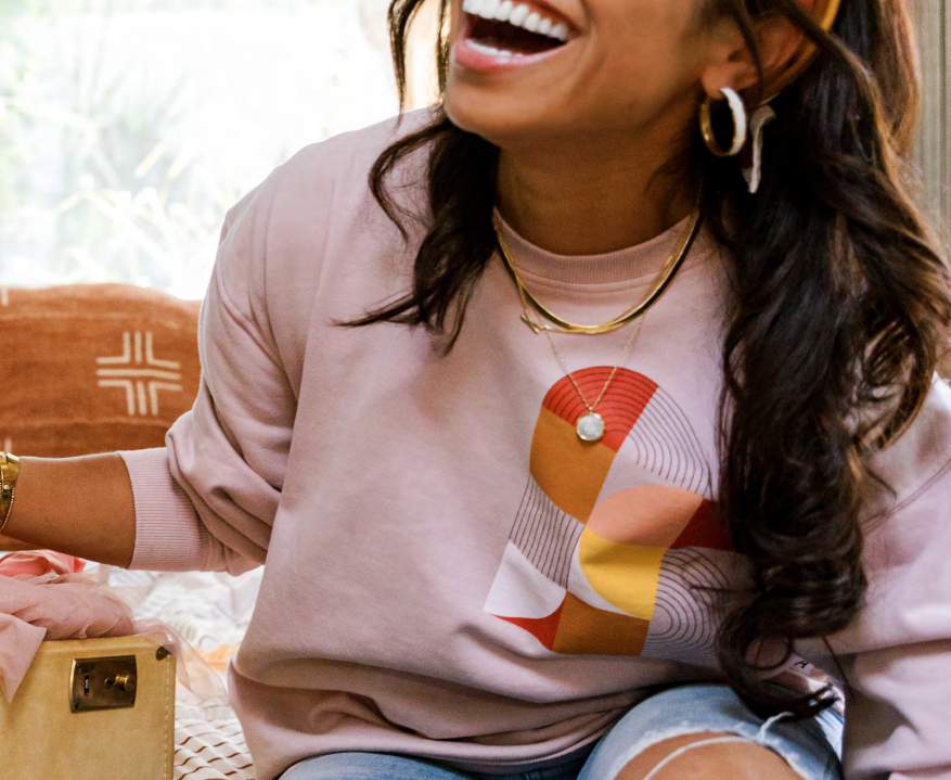 Model wearing an Airstream-inspired graphic sweatshirt