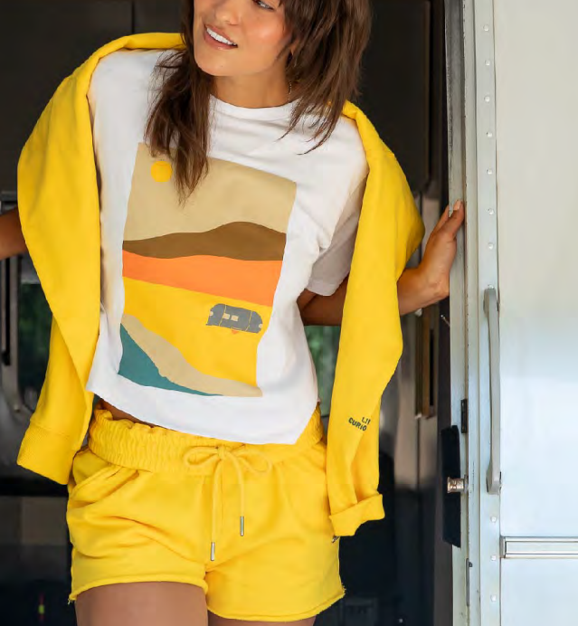 Model wearing an Airstream desert graphic tee and yellow lounge set